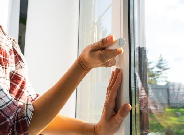 A woman's hands closing a window